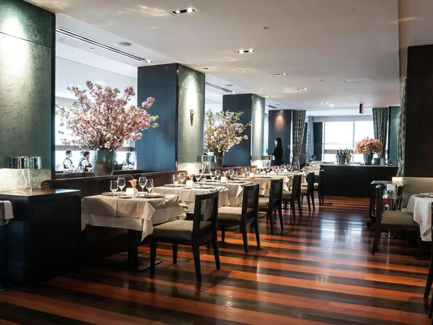 Elegant dining room interior at Ai Fiori restaurant in New York City with floral decor.