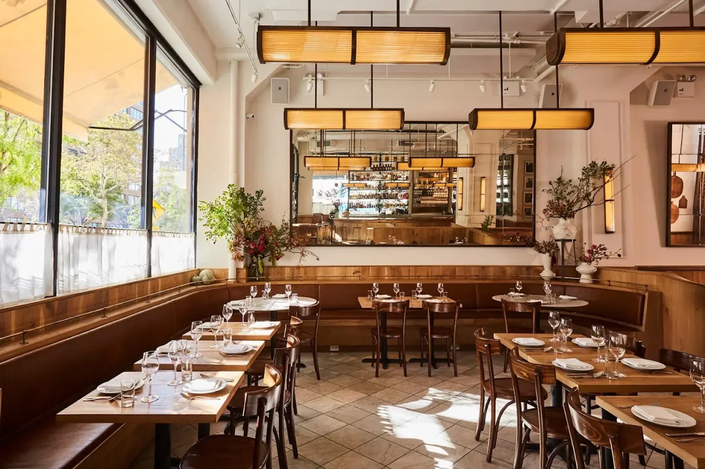 Cozy interior of Altro Paradiso in New York City with wooden tables and bar