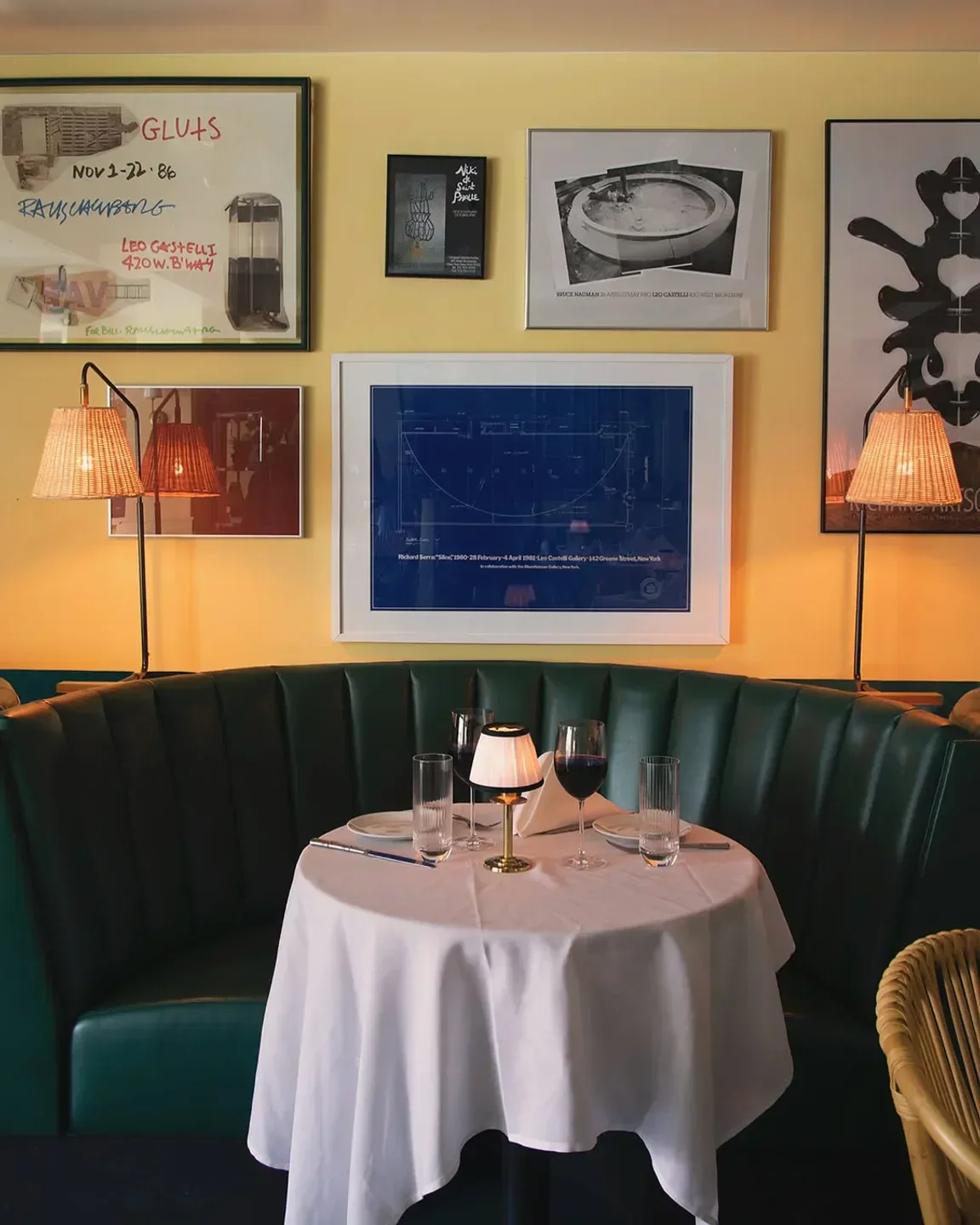 Cozy corner table at American Bar, a New York City restaurant, with art on the wall