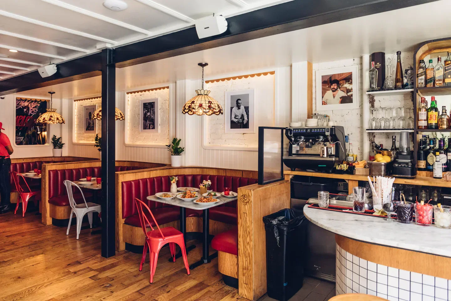 Cozy interior of Arthur and Sons restaurant in New York City with booths and bar area