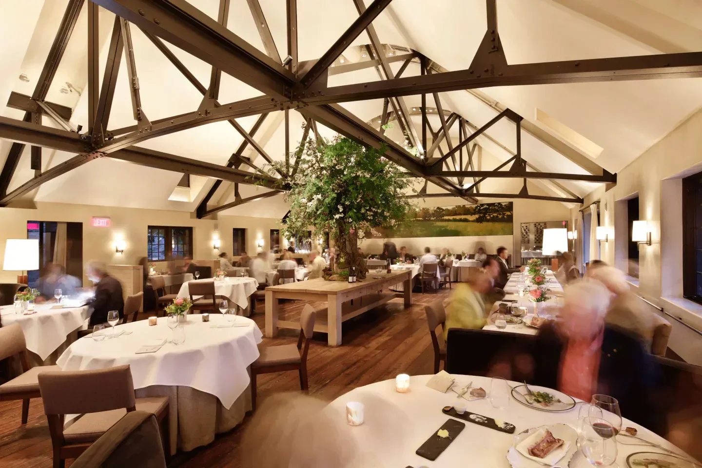 Elegant dining room at Blue Hill at Stone Barns in New York City with floral centerpiece.