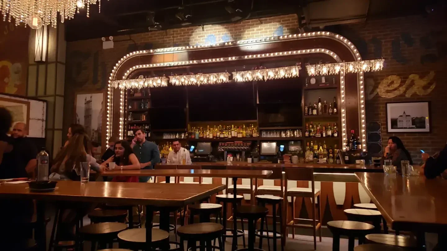 Interior view of BLUE nightclub in New York City with people at the bar
