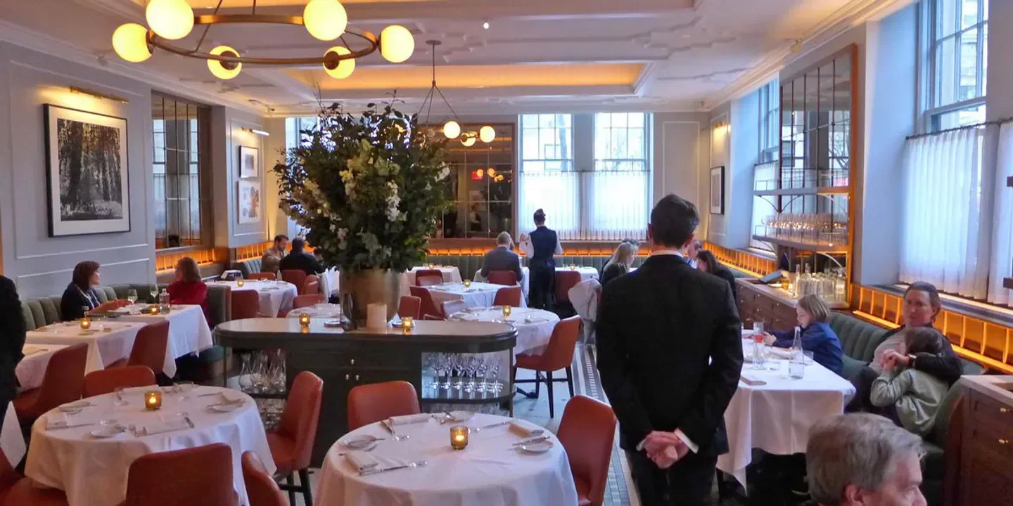 Elegant interior of Café Boulud in New York City with tables and guests dining