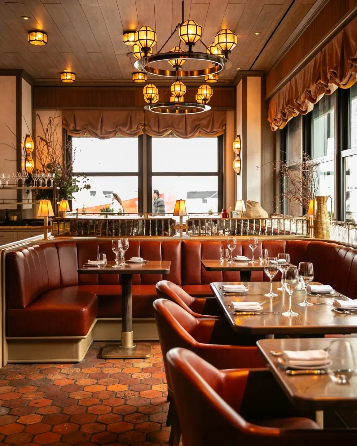 Cozy dining area at Carne Mare in New York City with stylish leather booths and decor.