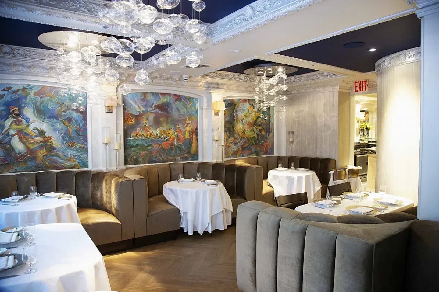 Caviar Russe in New York City: Elegant restaurant interior with artistic murals and seating.