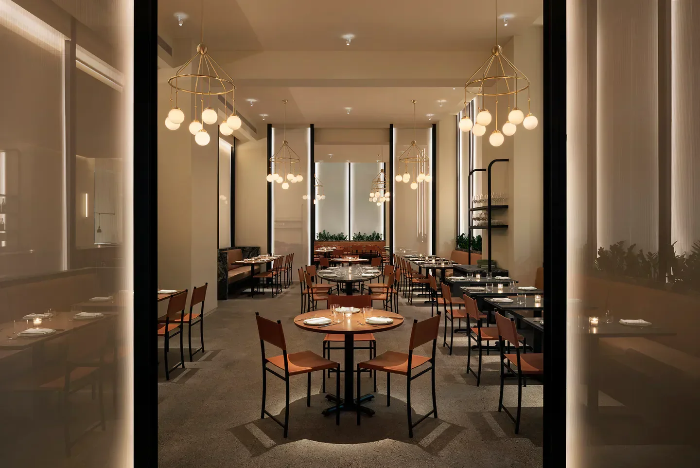 Elegant dining room interior at Crown Shy restaurant in New York City with stylish lighting.