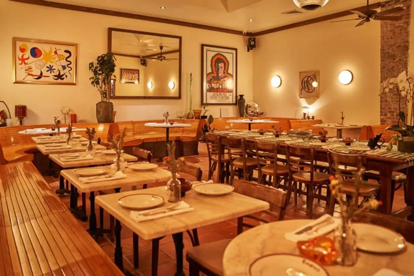 Cozy dining area at Emmett’s On Grove in New York City, with warm lighting and tables.