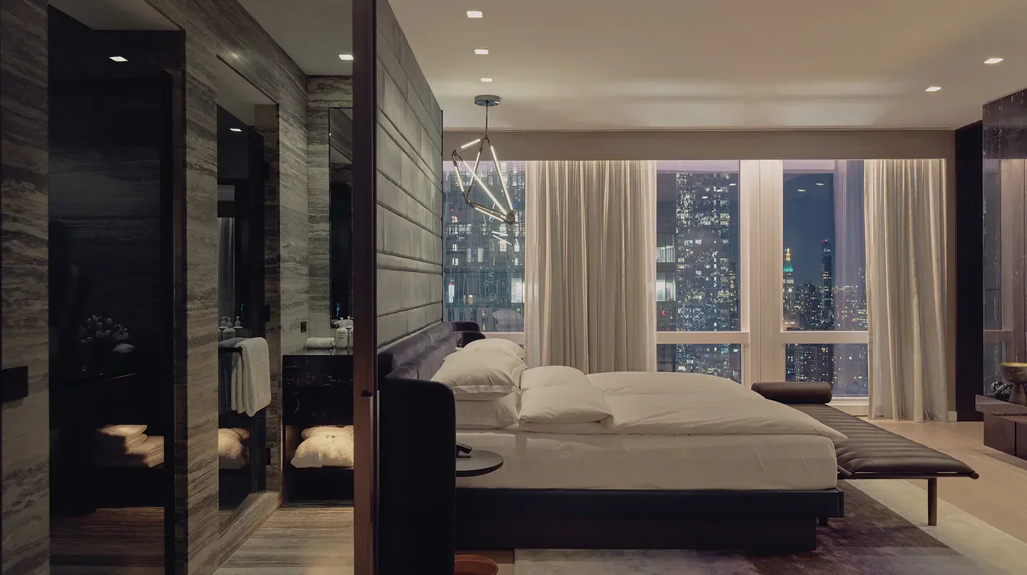 Elegant bedroom at Equinox Hotel New York with stunning New York City skyline views.
