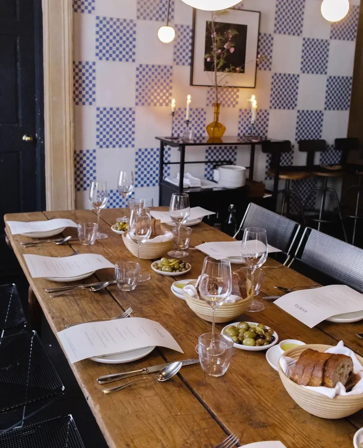 Table setting at Estela, a New York City restaurant, featuring olives and bread.