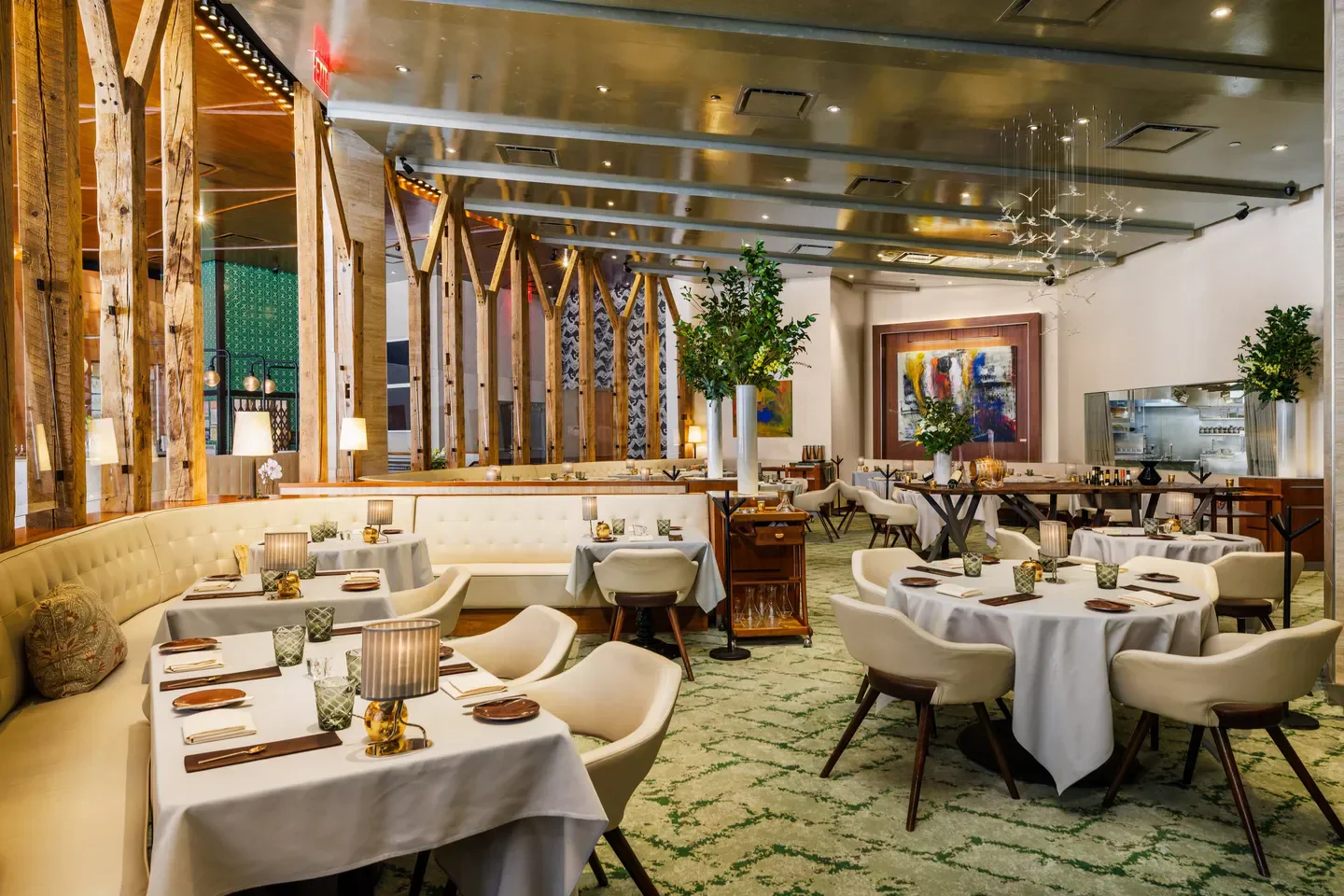 Elegant dining area at Gabriel Kreuther in New York City with wooden beams and art.