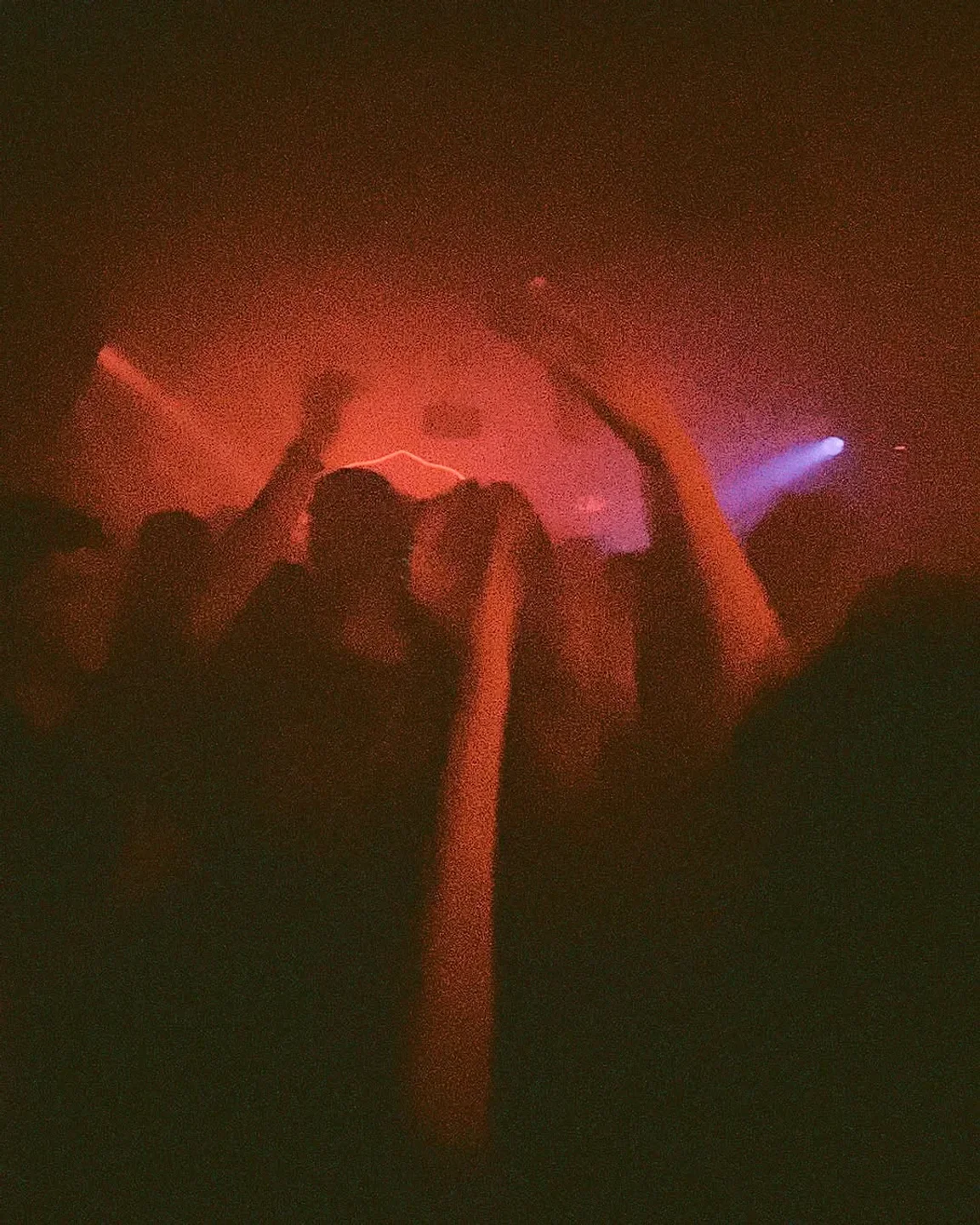 Crowd dancing under red lights at Gabriela nightclub in the city