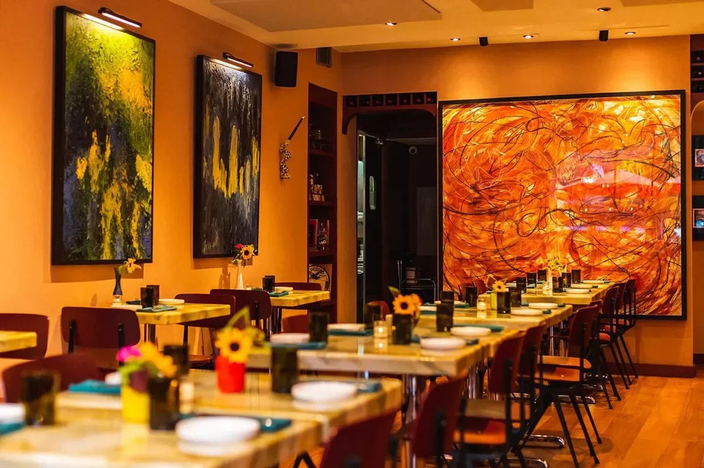 Interior of Gab’s restaurant in New York City with artwork and tables set.