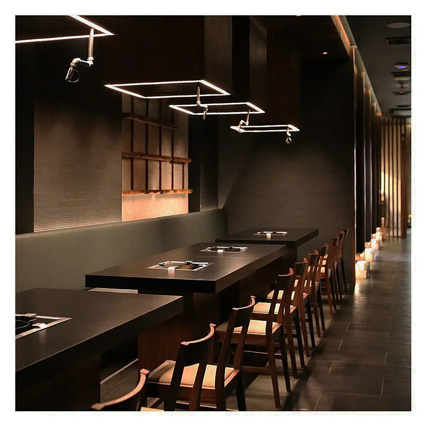 Interior of HYUN restaurant in New York City with modern decor and seating.