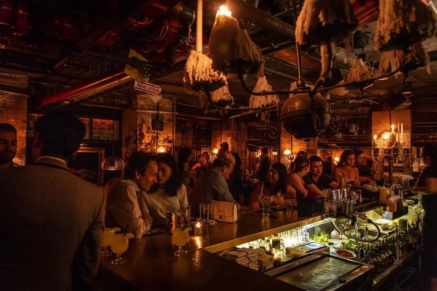 Inside La Esquina in New York City: cozy bar scene with candlelit ambiance.