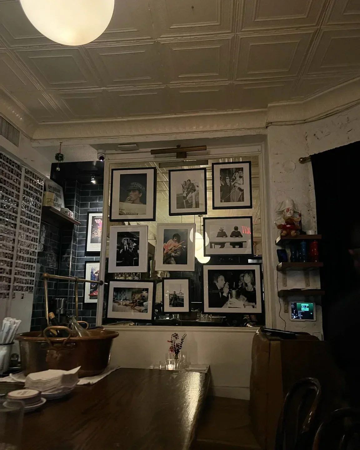 Interior of Little Prince in New York City with framed photos and ambient lighting.