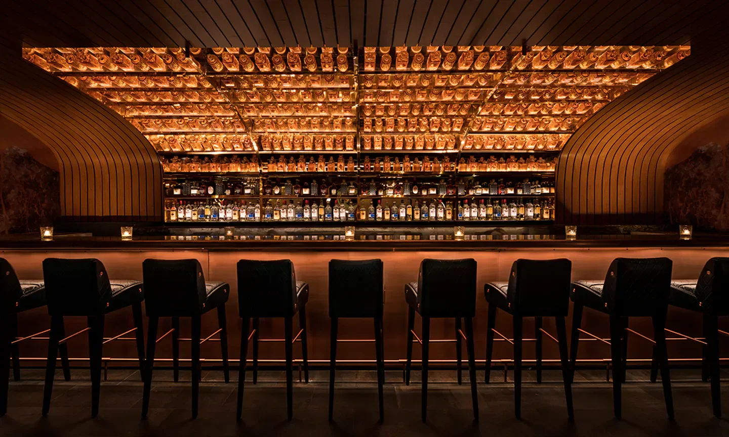 Interior of Little Sister Lounge in New York City with a beautifully lit bar.