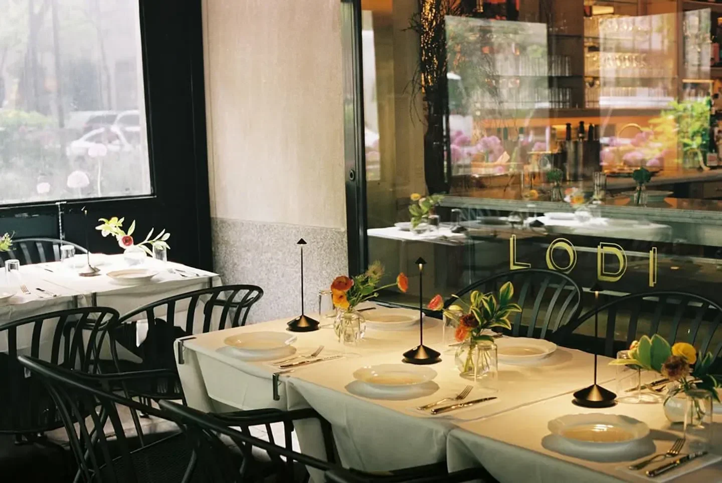 Interior dining at Lodi in New York City with elegant table settings and decor.