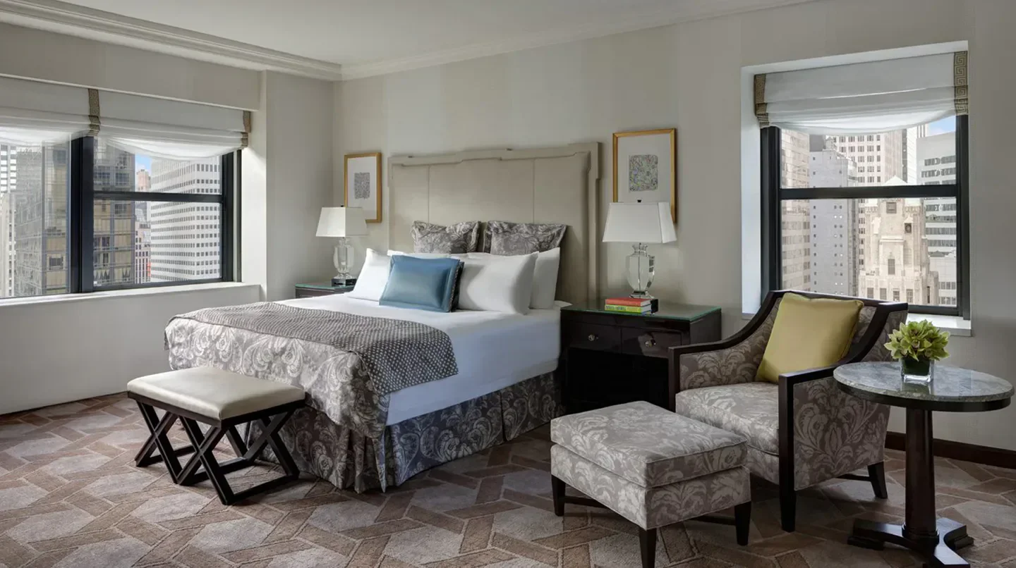 Cozy bedroom at Lotte New York Palace with city views in New York City.