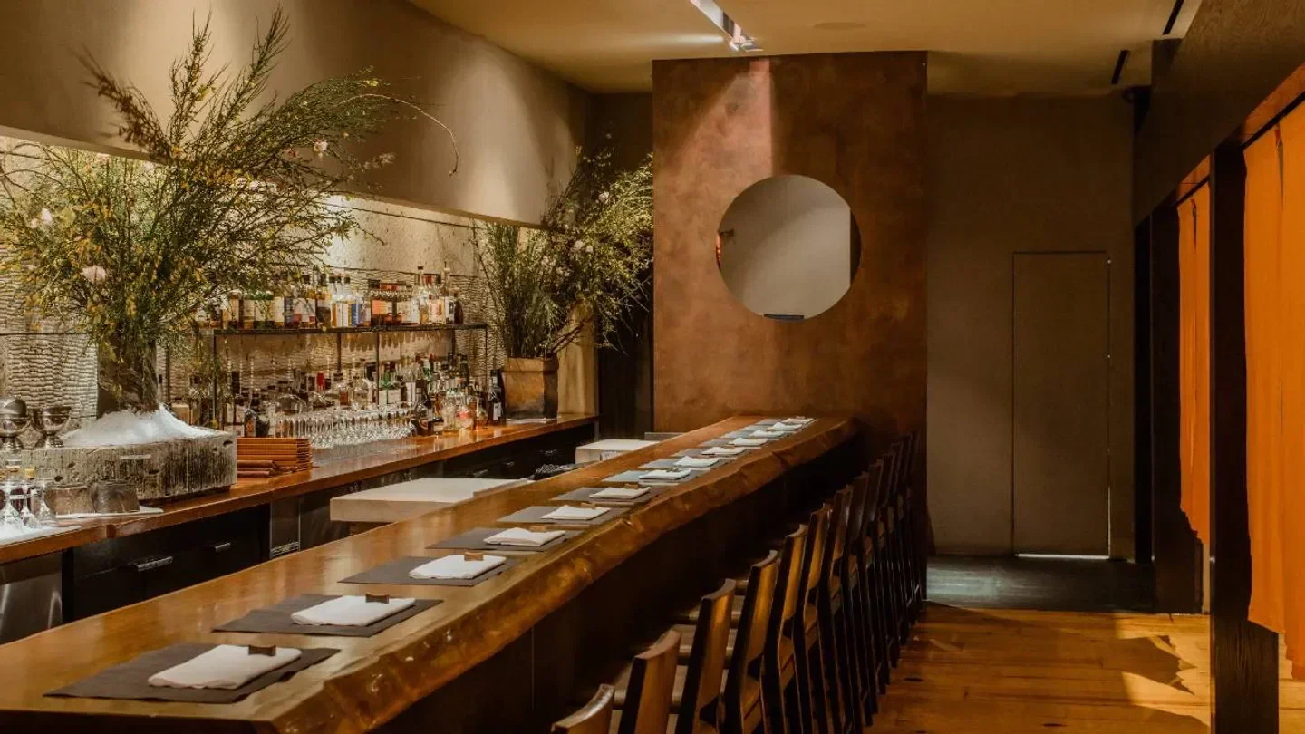 Interior of Masa in New York City with a long wooden counter and decor