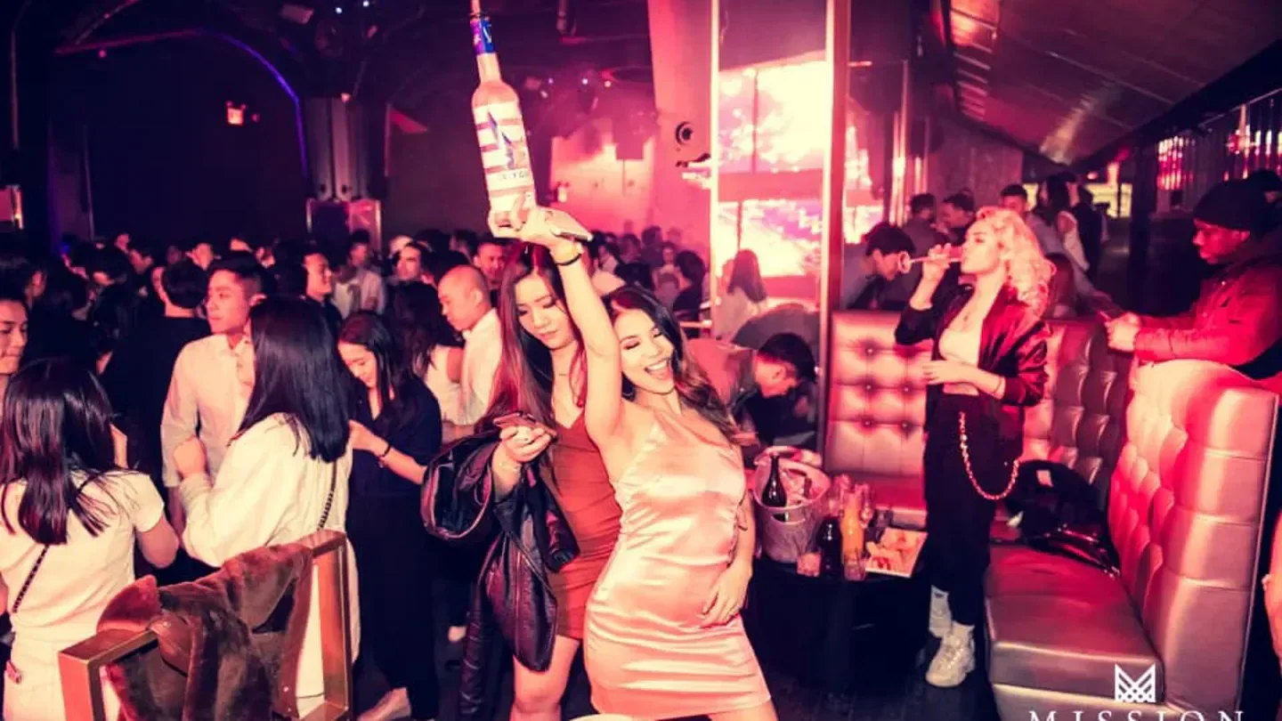 Energetic party scene at Mission Nightclub in New York City with dancing and drinks