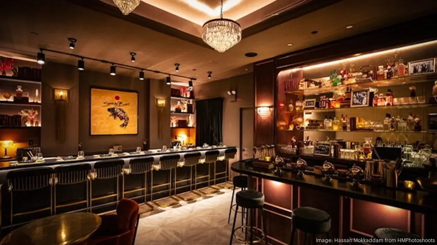 Interior view of Moody Tongue in New York City with bar and artwork.