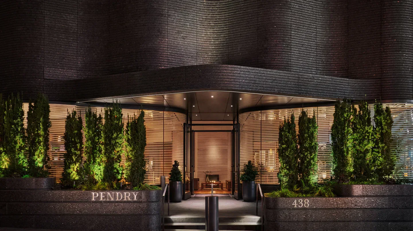 Entrance to Pendry Manhattan West in New York City at night, modern architecture.