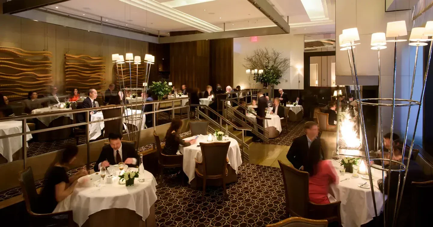 Elegant dining room at Per Se in New York City, featuring stylish decor and tables.