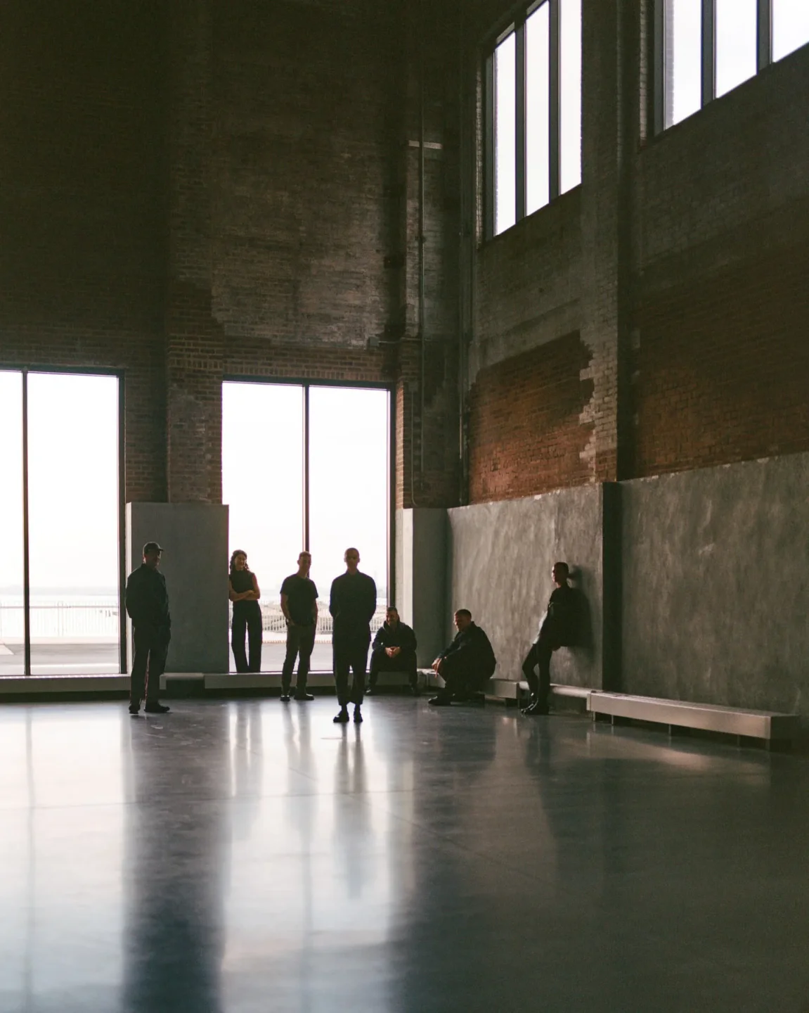 Interior of Public Records nightclub in the city, featuring large windows and a group of people standing.