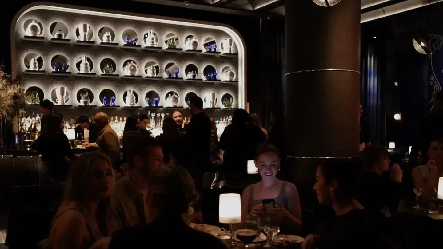 Inside Silver Lining Lounge in New York City: stylish bar and patrons enjoying drinks