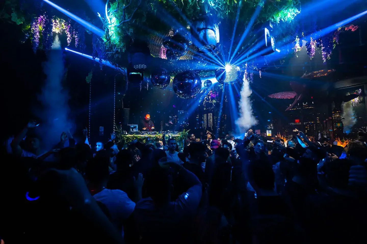 Energetic nightclub scene at Somewhere Nowhere in New York City with dancing crowds.