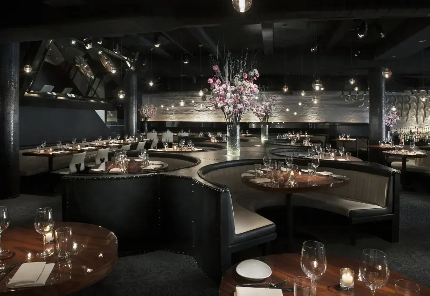 STK New York City restaurant interior with unique seating and floral arrangements