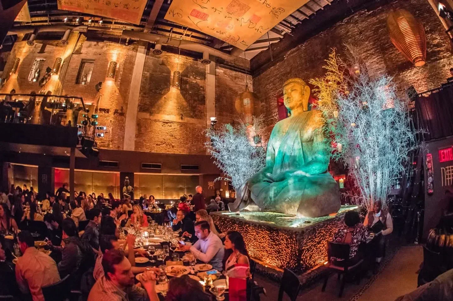 TAO Uptown in New York City features a Buddha statue and busy dining room.