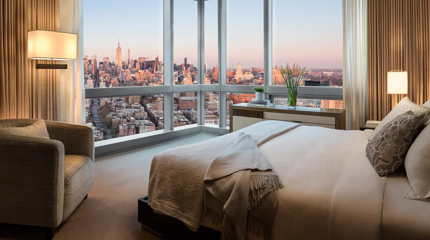Bedroom view from The Dominick Hotel in New York City with cityscape visible.