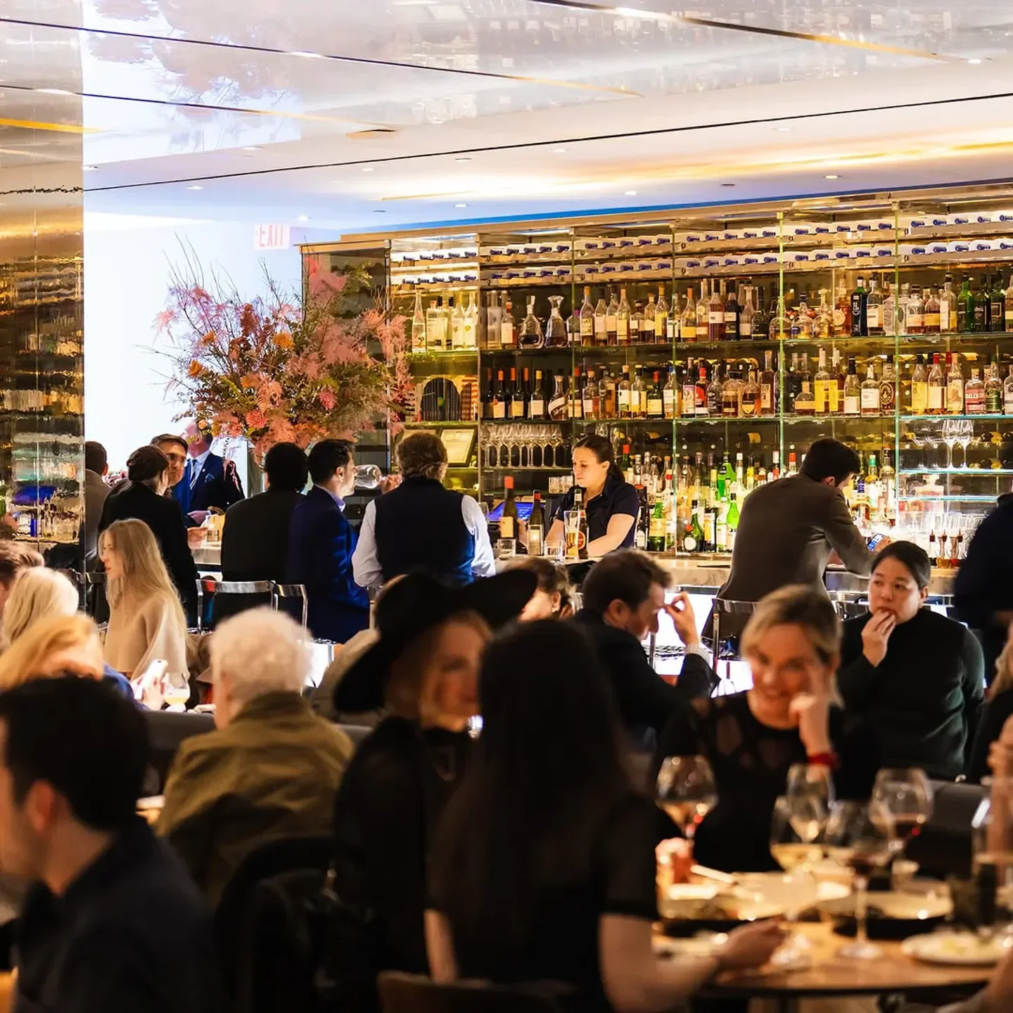 Dining at The Modern restaurant in New York City with a busy bar and patrons.