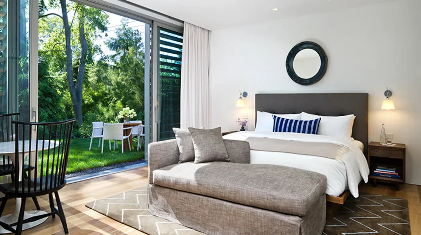 Bedroom interior at Topping Rose House in New York City with garden view and modern design